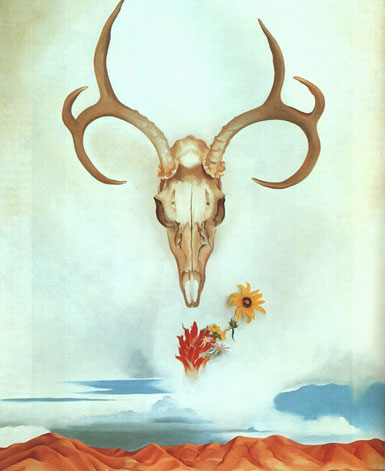 A bleached deer skull hangs in a desert sky